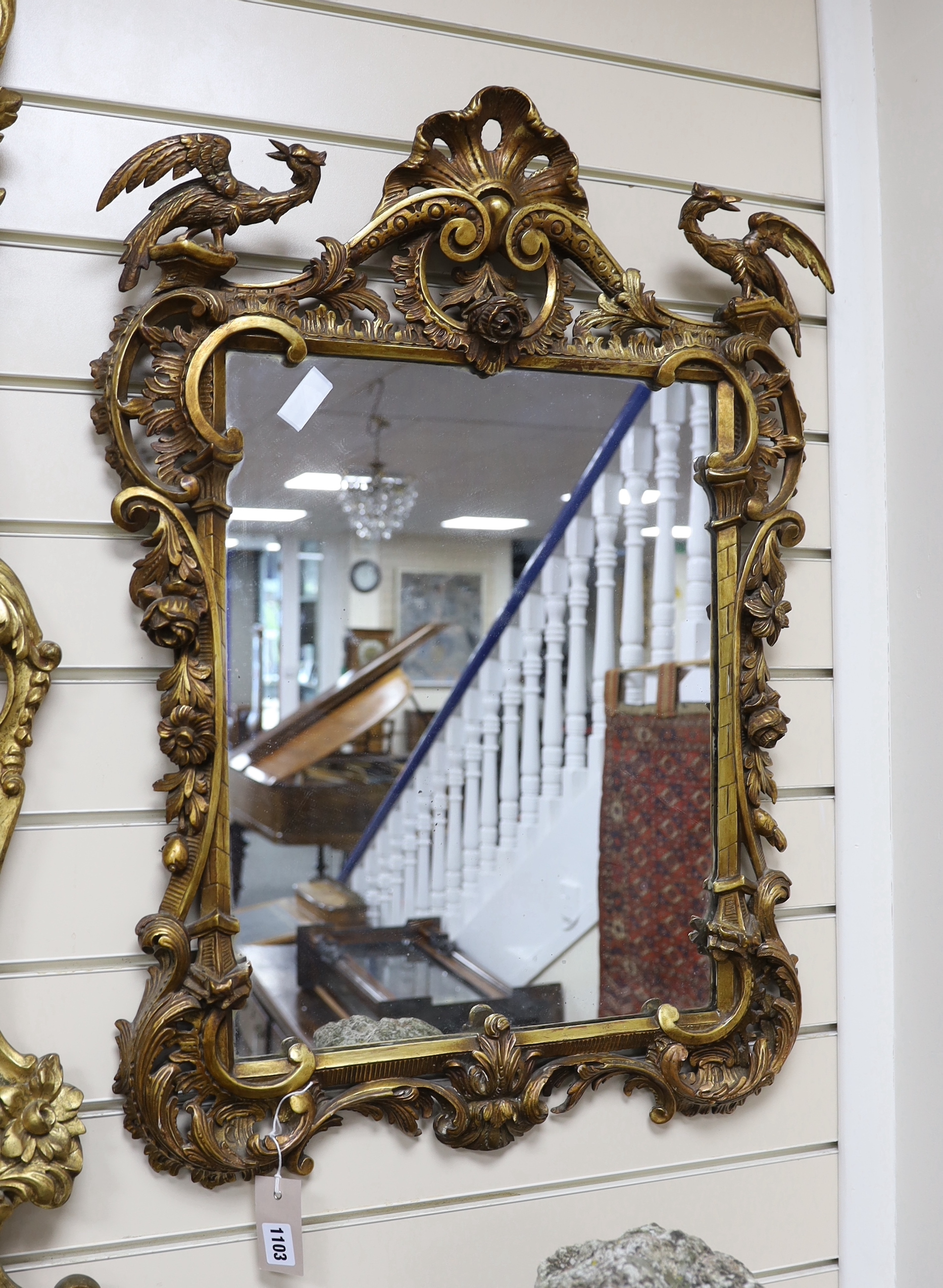 An early 20th century Chippendale revival carved giltwood and composition wall mirror, width 57cm, height 78cm